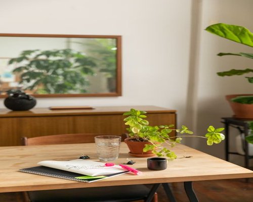 Organized desk with natural light highlighting a glass of water